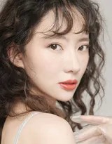 刘萌萌漫步于秋意盎然的室外，身穿休闲套装，步履轻盈，笑容清新如风