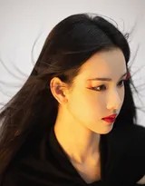 黑色背景下陈都灵蓦然回首，珠帘面纱与飞扬发丝勾勒出动感瞬间，眼眸中闪烁着洞察一切的锐利光芒