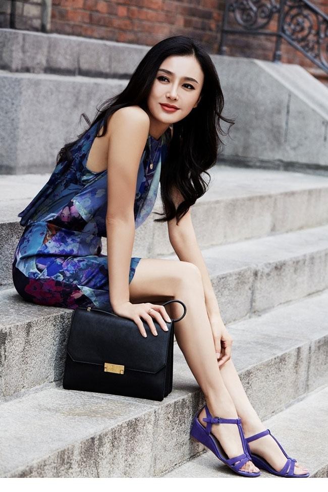 秦岚手持玫瑰眼眸含情凝视镜头，鲜艳花瓣与红唇相映妩媚动人