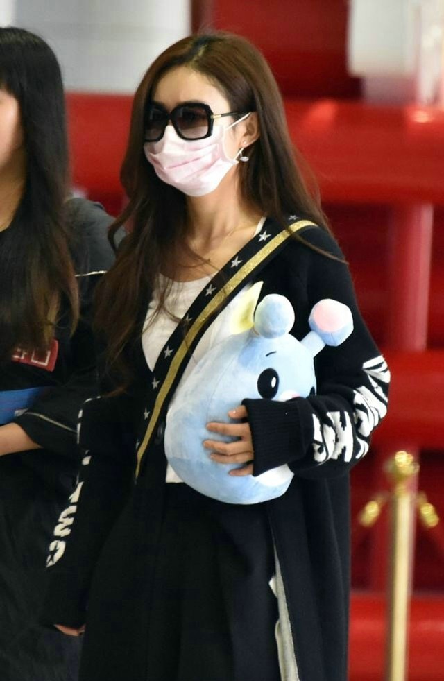 赵丽颖针织暖衫携萌宠现身机场 毛绒玩偶展露反差少女心