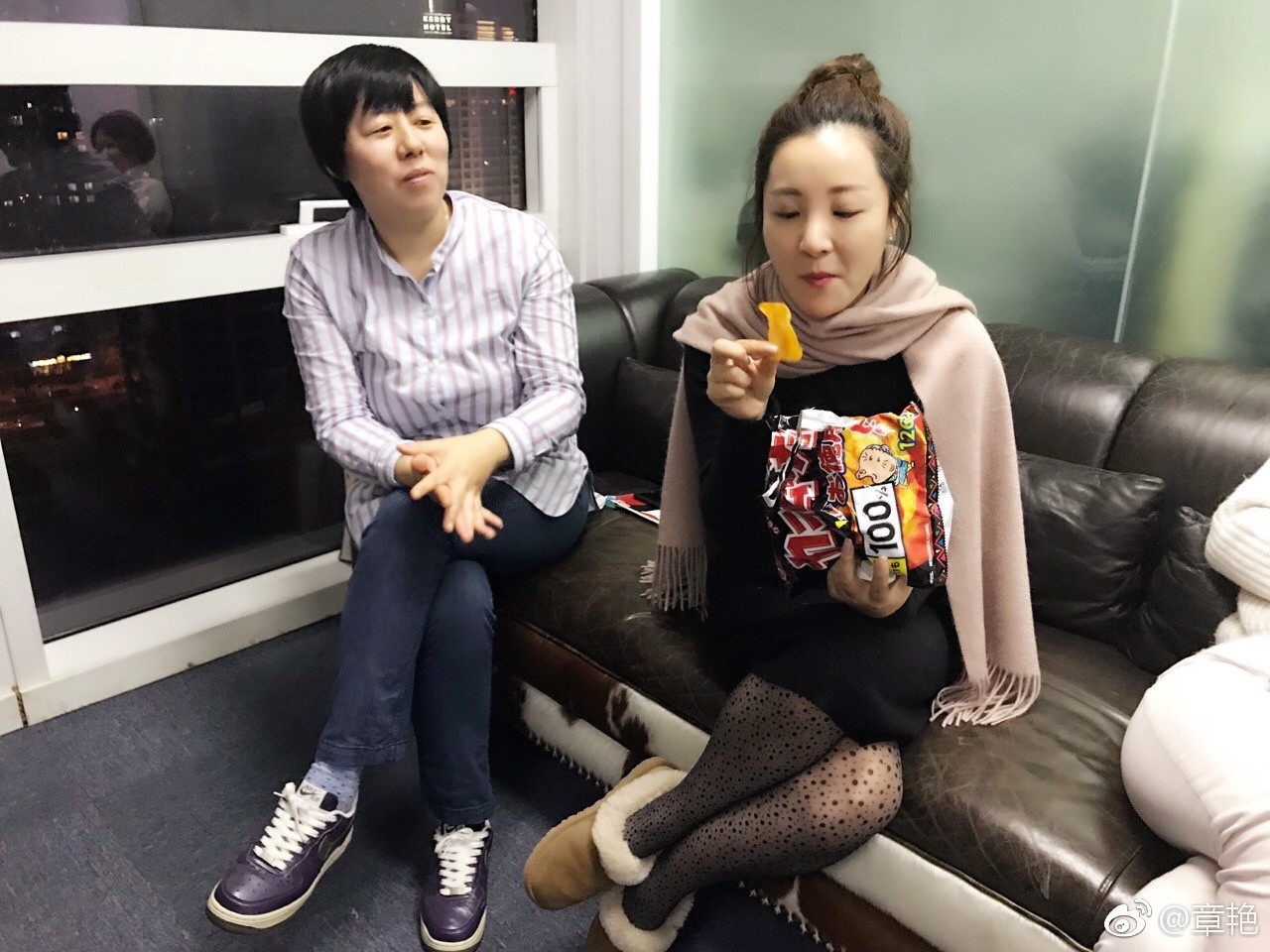 章艳坐在高脚凳上轻松交谈，姿态随意自然，捕捉到其生活中亲切可人的一面