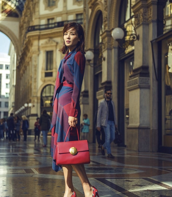 刘涛依靠斑驳墙面若有所思，光影分割画面构成文艺电影场景