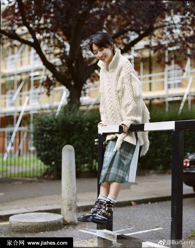 周冬雨低头前行，大衣下摆随风轻动，捕捉动态中的静谧之美