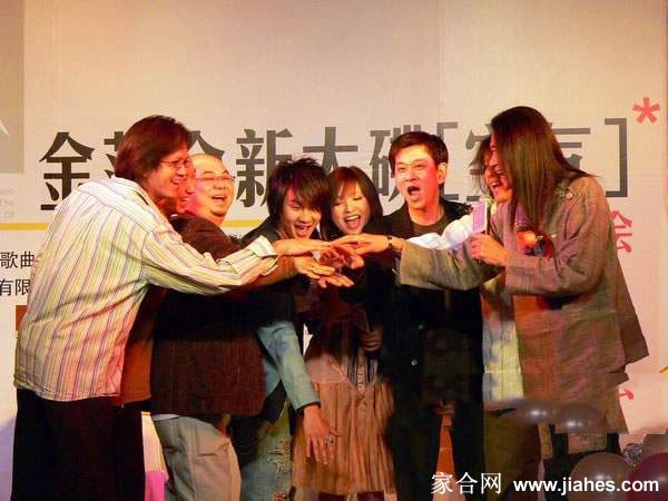 金莎低头翻阅专辑资料神情专注 微卷长发自然垂落更添柔美